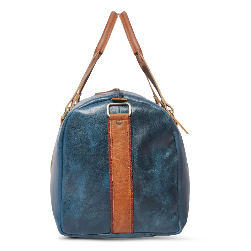 Blue leather bag with brown strap on a white background