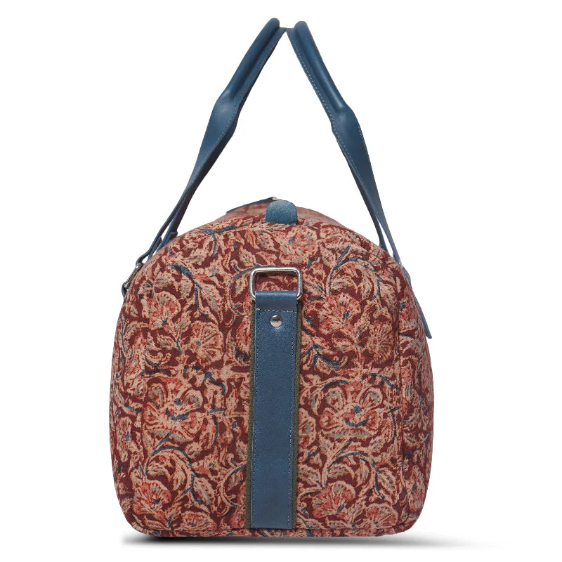 Floral-patterned bag with blue straps on a white background