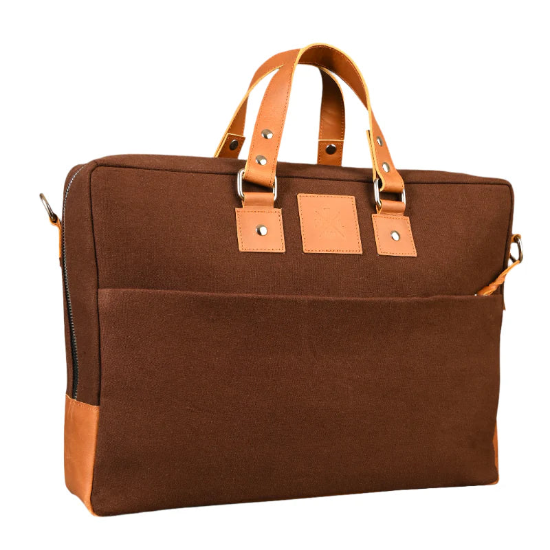 Brown bag with leather straps and accents on a white background