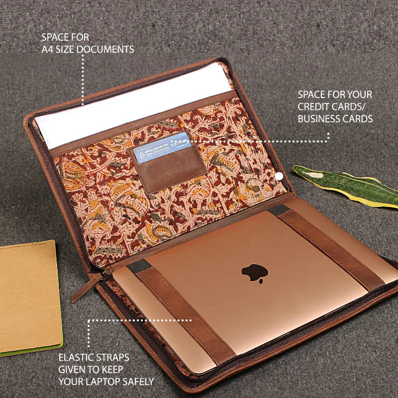 Brown laptop sleeve with patterned interior, elastic straps, and card slots on a gray background