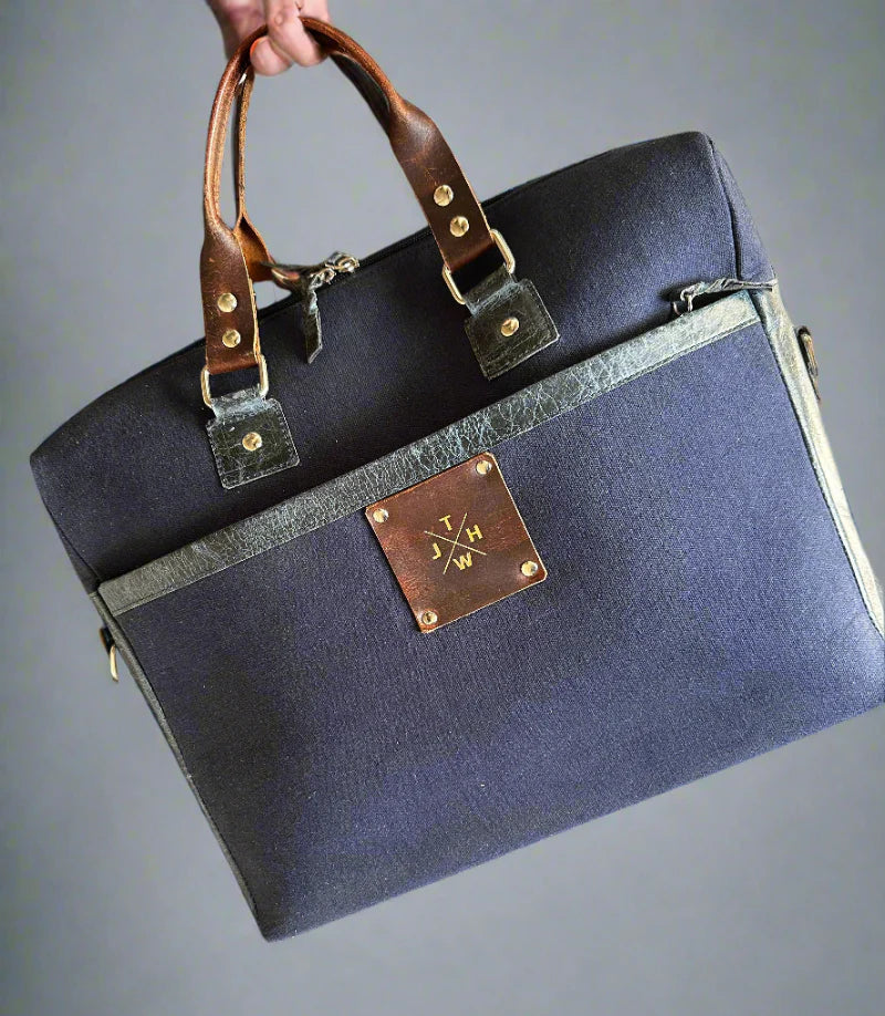 Blue leather briefcase with gold accents on a gray background