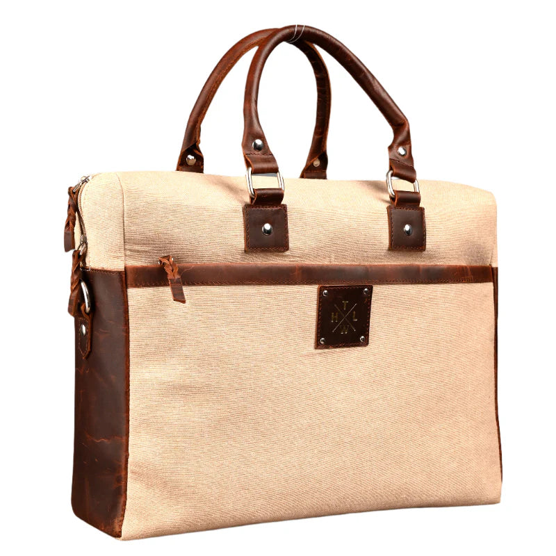 Beige briefcase with brown leather accents on a white background