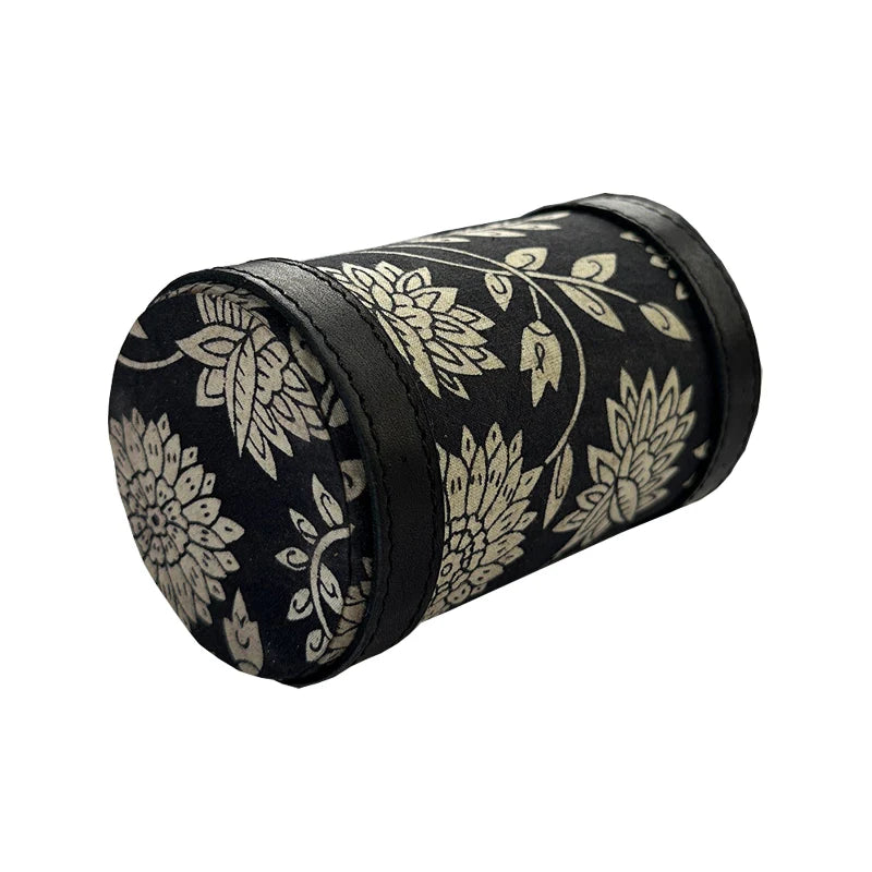 Black cylindrical container with gold floral patterns on a white background