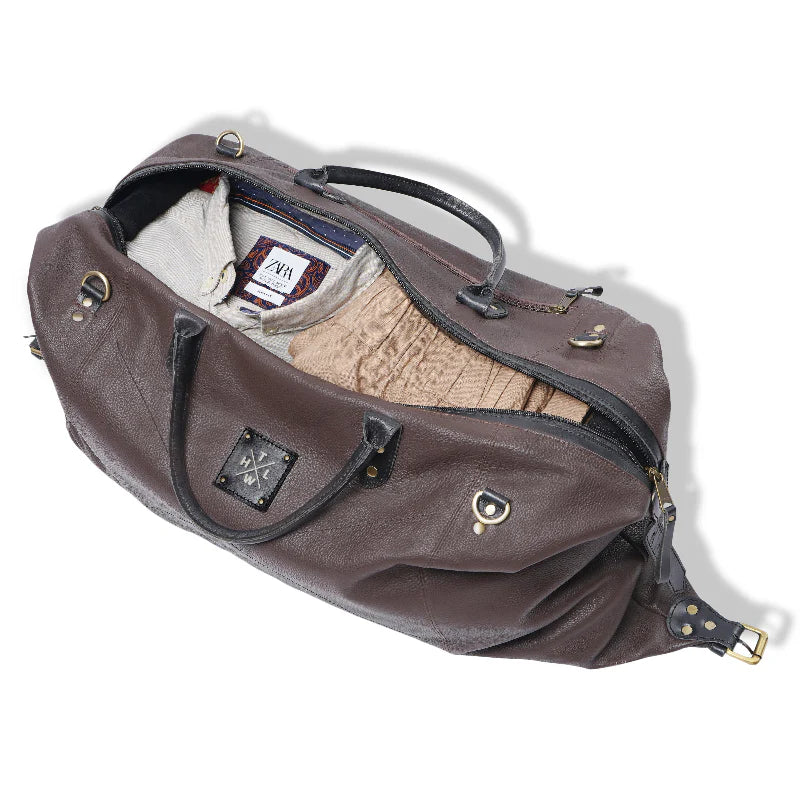 Brown leather handbag with gold accents on a white background