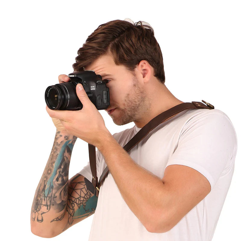 Man holding a camera against a white background