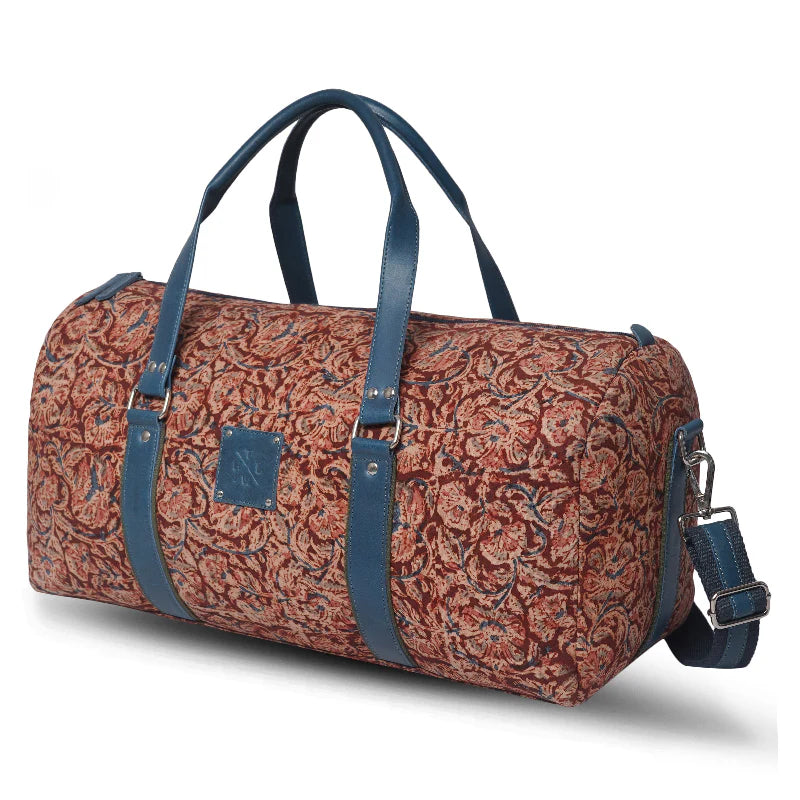 Duffel bag with floral pattern and blue straps on a white background