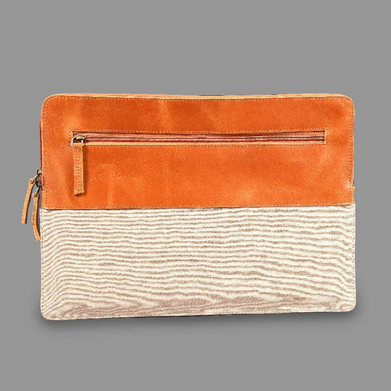 Two-tone clutch bag with orange top half and beige bottom half on a gray background