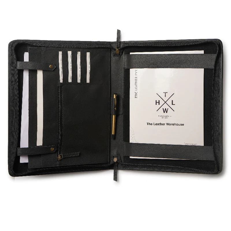 Black leather portfolio with pen holder and paper inside, featuring The Leather Warehouse logo.