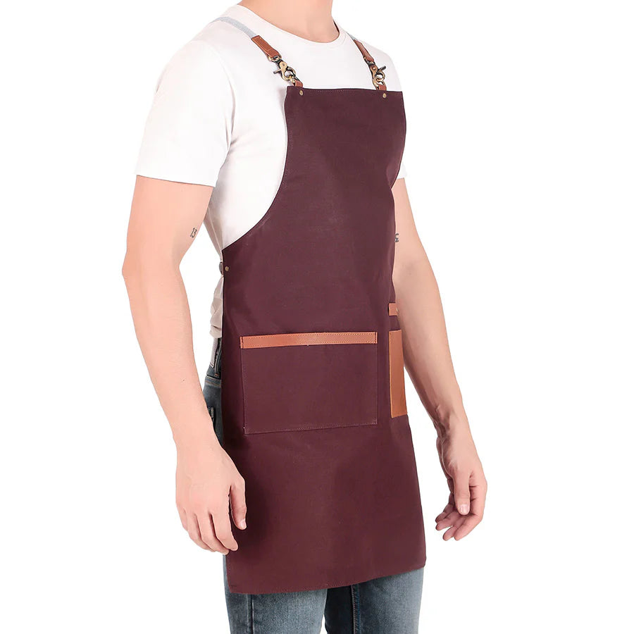Person wearing a brown apron with leather straps on a white background