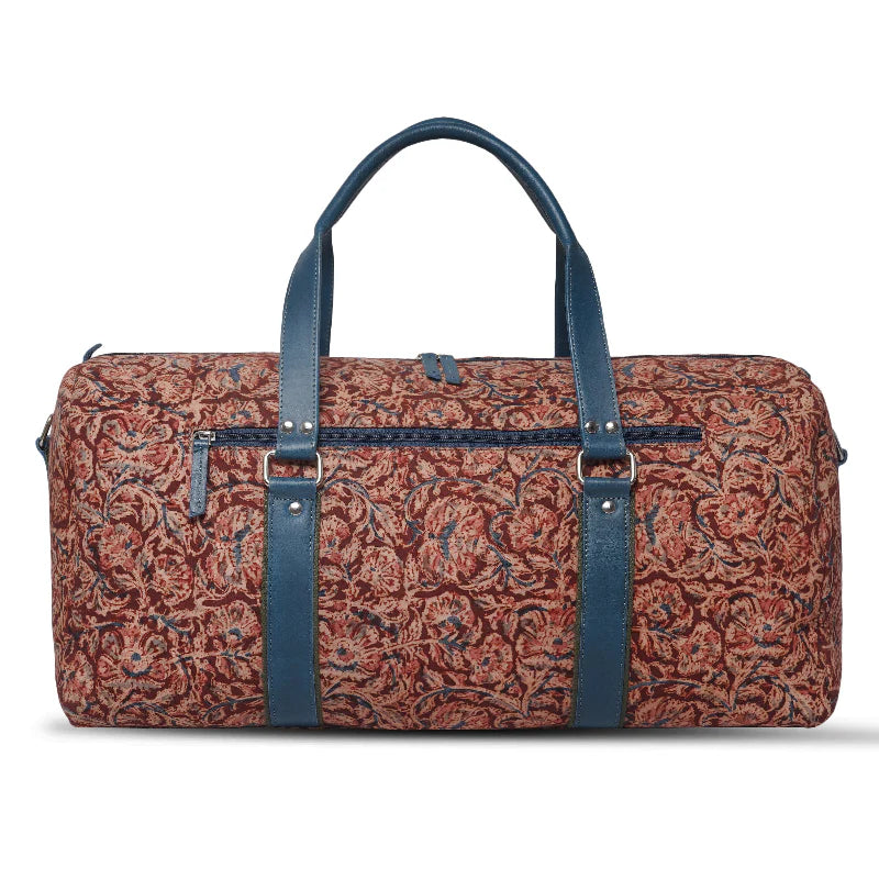 Patterned duffel bag with blue straps on a white background