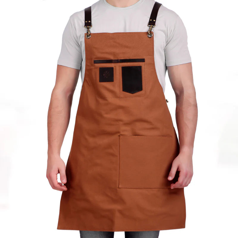 Brown apron with black accents worn by a person on a white background