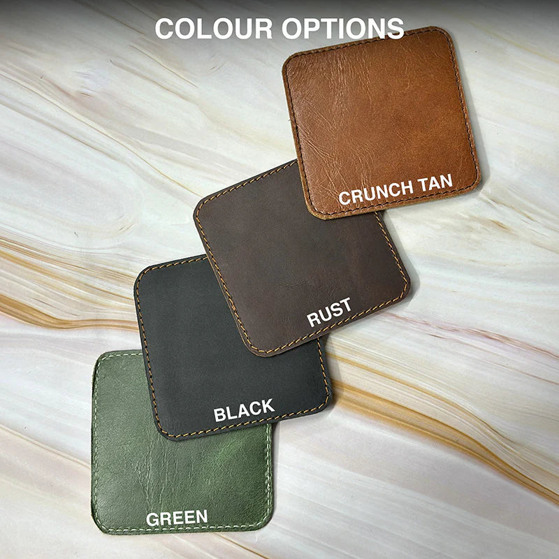 Three leather coasters in different colors on a marble surface with color names.