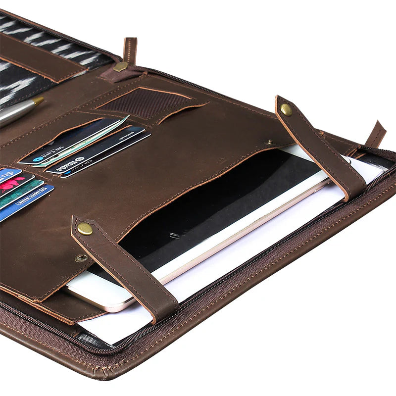 Brown leather organizer with compartments for pens, cards, and a phone on a white background