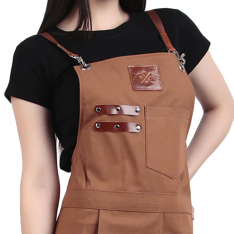 Brown apron with leather straps and accents on a plain background
