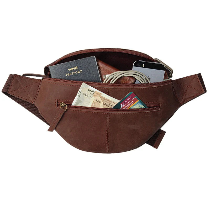 Brown waist bag with various items including a passport, money, and phone on a white background