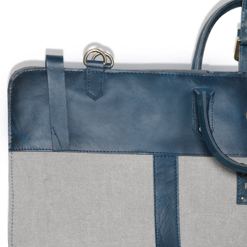 Gray tote bag with blue leather accents on a white background
