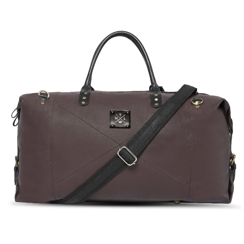 Brown leather duffel bag with black strap on a white background