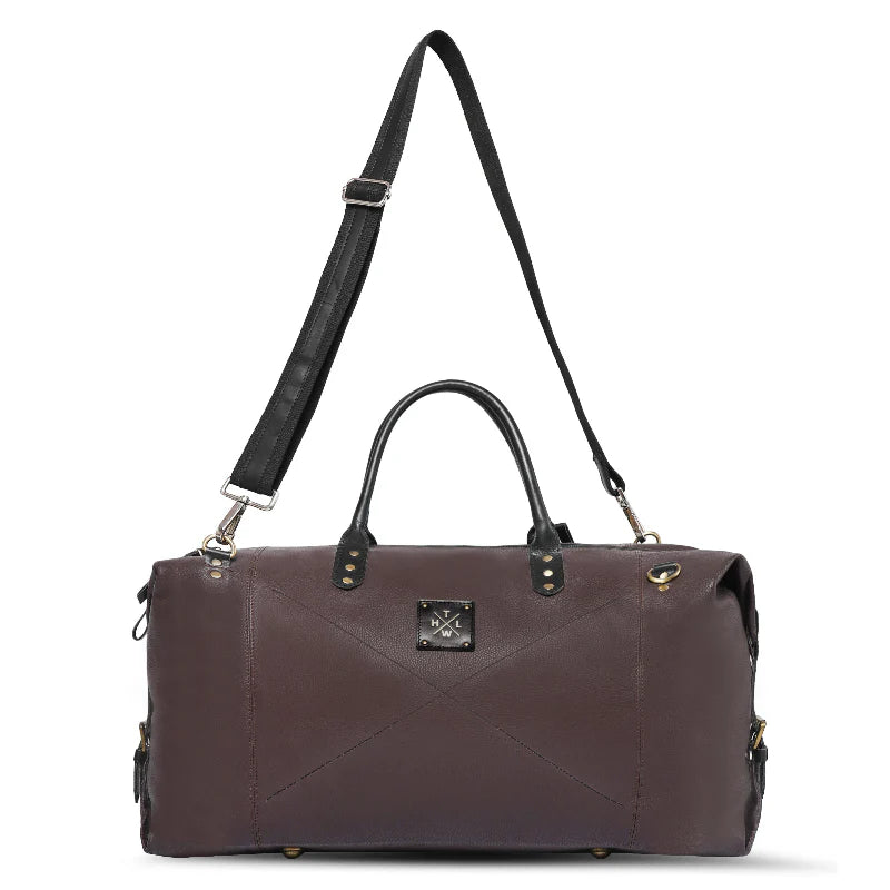 Brown leather duffel bag with black strap on a white background