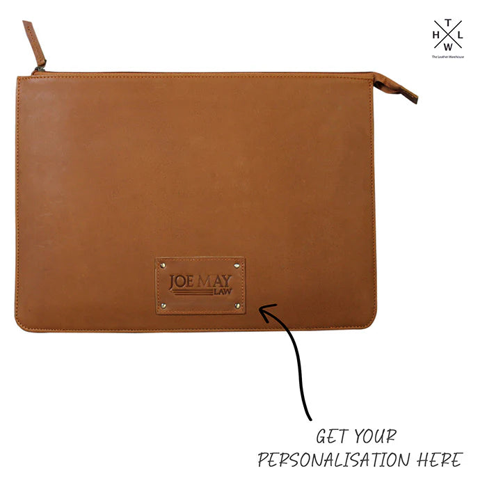 Brown leather pouch with a personalized nameplate on a white background