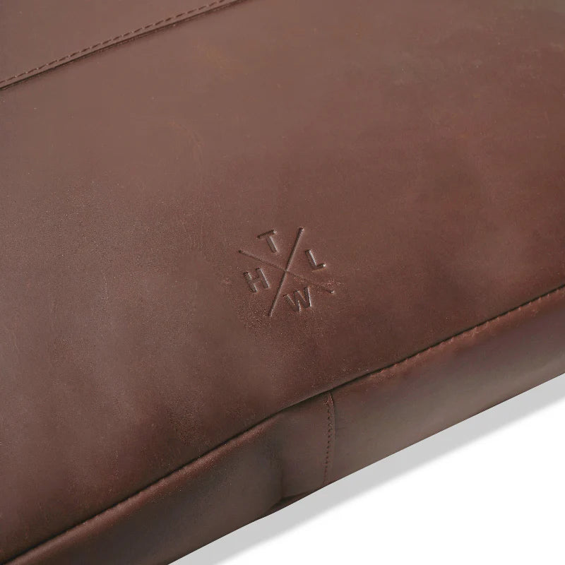 Brown leather product with a logo on a white background