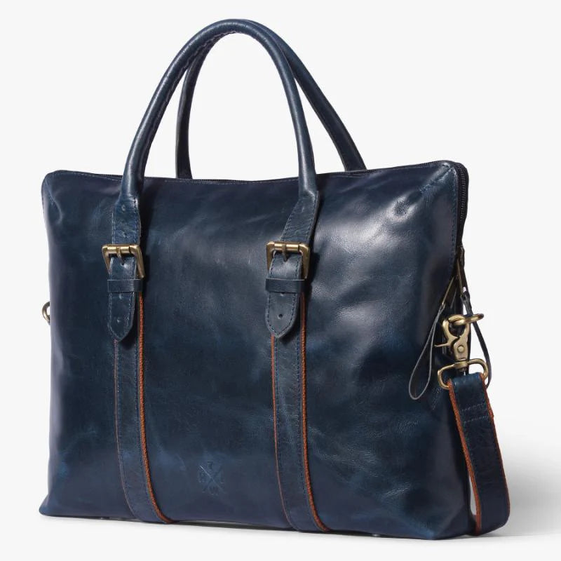 Blue leather handbag with gold accents on a white background