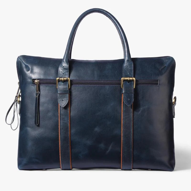 Blue leather bag with gold accents on a white background