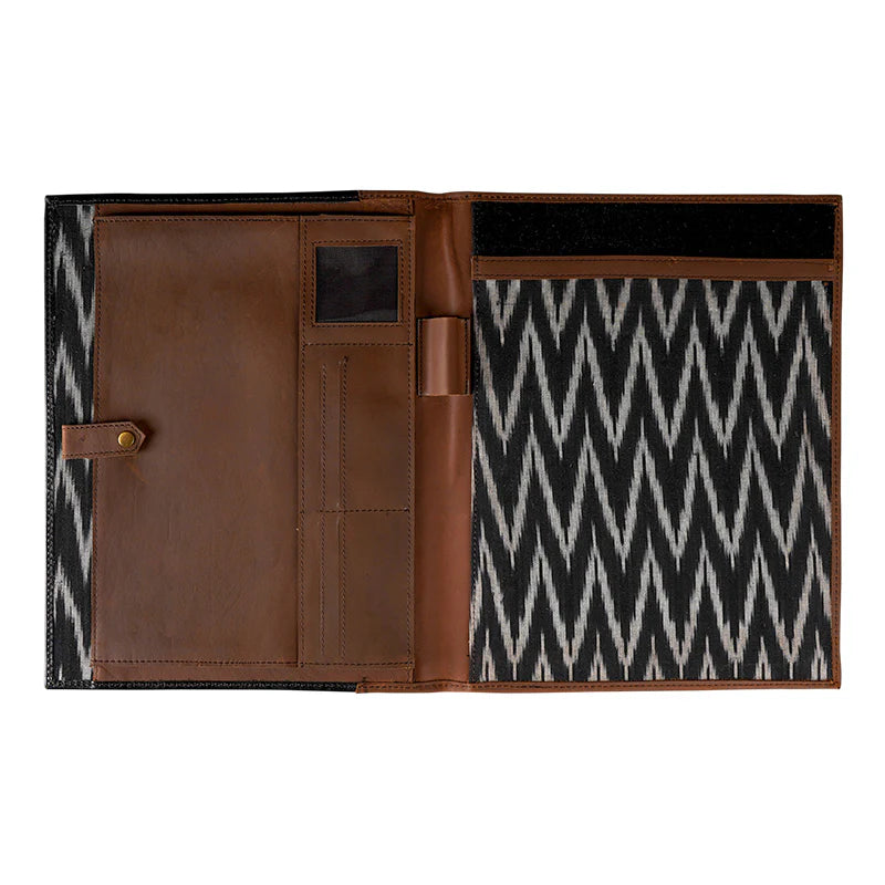 Brown leather wallet with black and white zigzag pattern on a white background
