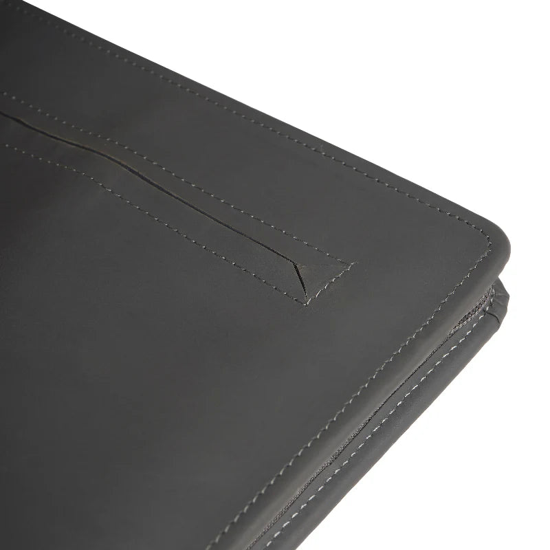 Close-up of a black leather wallet with stitching detail on a white background