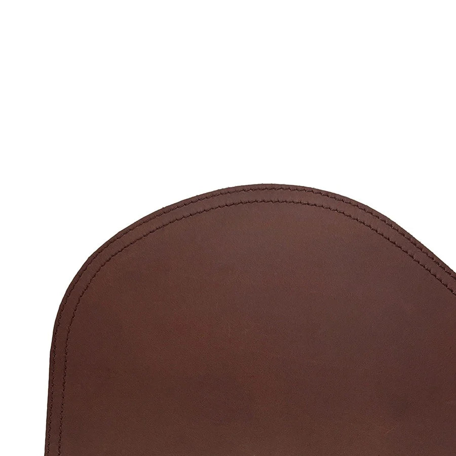 Close-up of a brown leather chair armrest on a white background