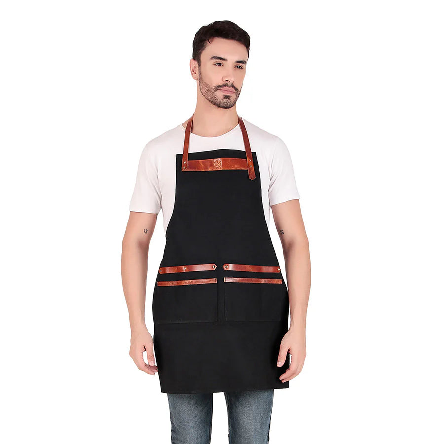 Man wearing a black apron with brown accents on a white background