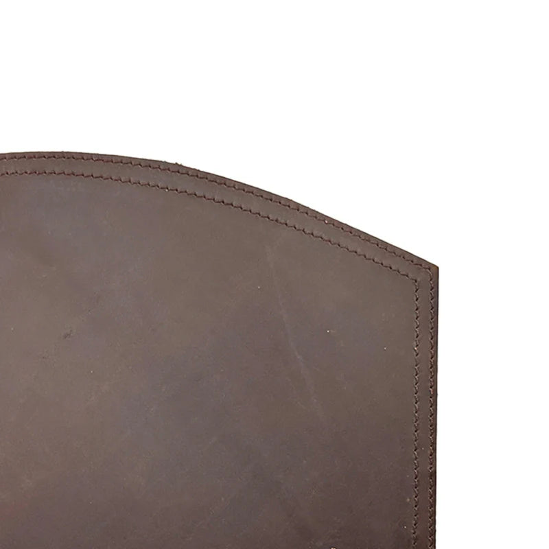 Close-up of a brown leather product with visible texture and stitching on a white background