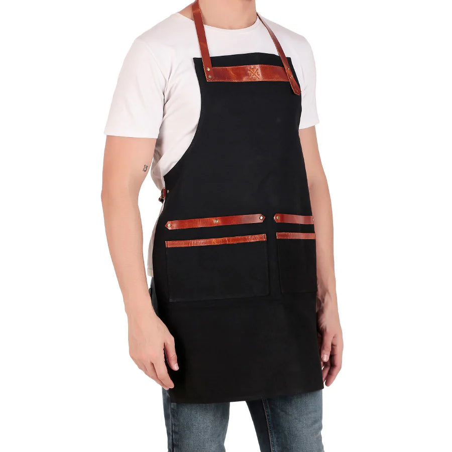 Person wearing a black apron with brown straps on a white background