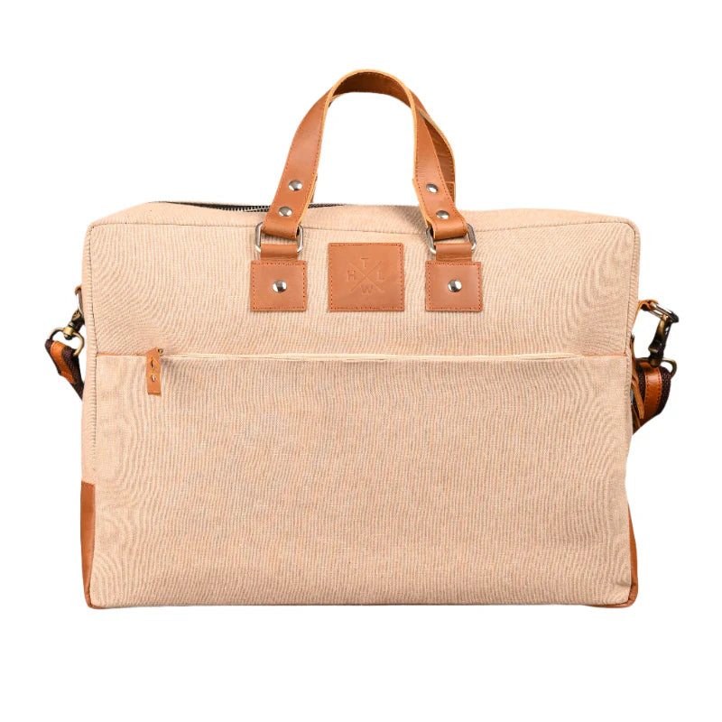 Beige canvas bag with brown leather straps on a white background