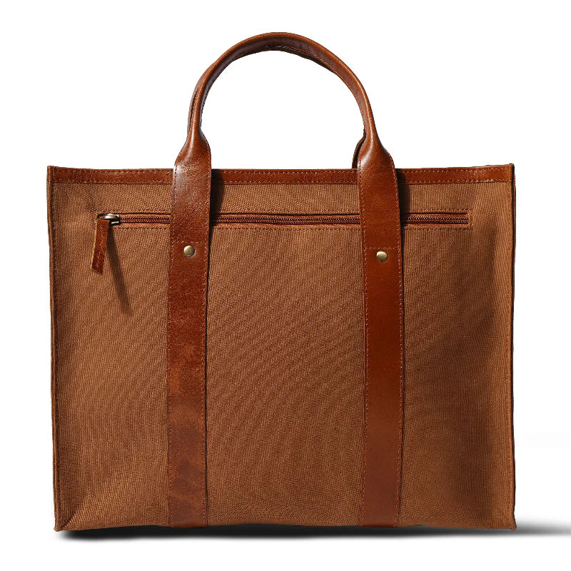 Brown tote bag with leather straps on a white background