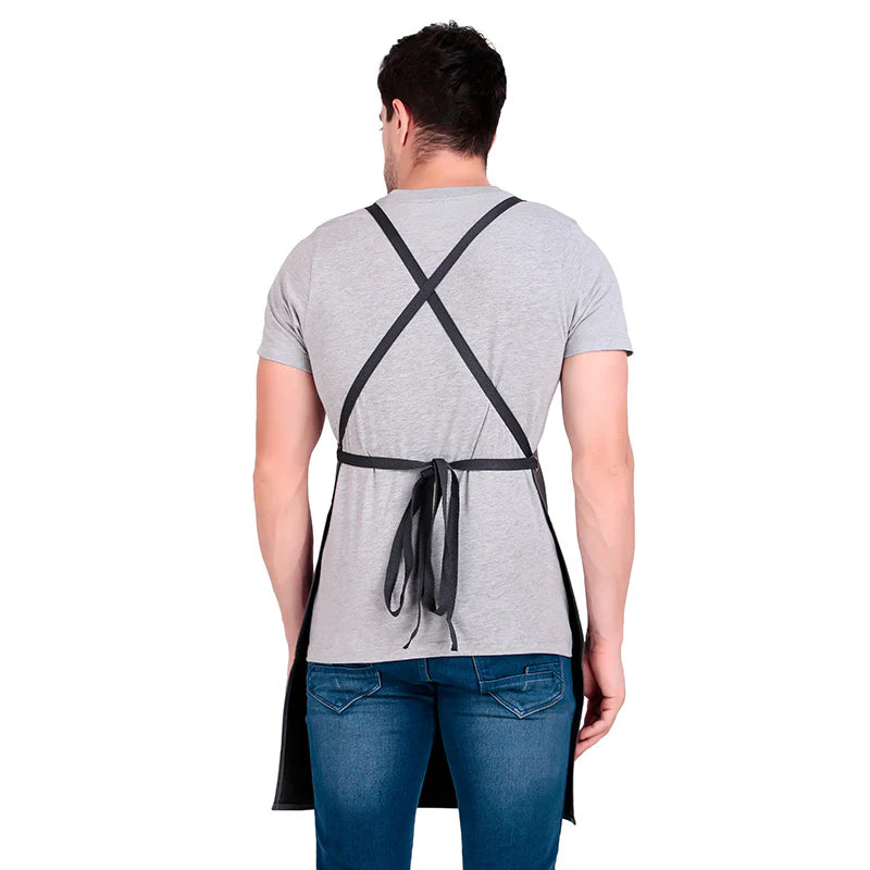 Person wearing a black apron over a gray t-shirt on a white background