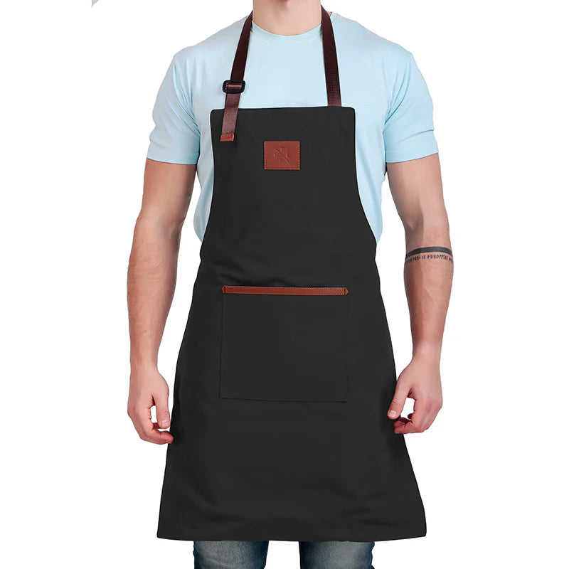 Person wearing a black apron with brown straps on a white background