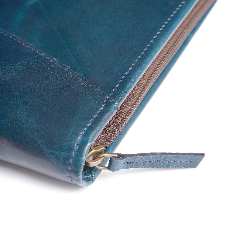 Close-up of a blue leather wallet with a zipper on a white background