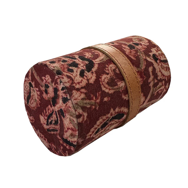 Cylindrical pouch with paisley pattern and gold zipper on a white background