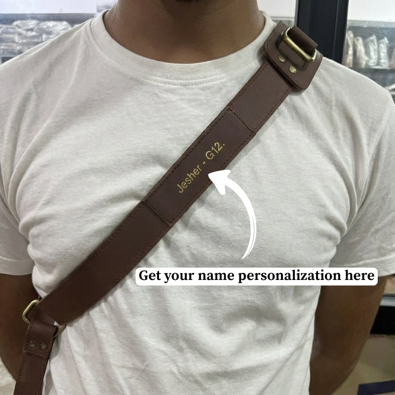 Person wearing a brown leather strap with &