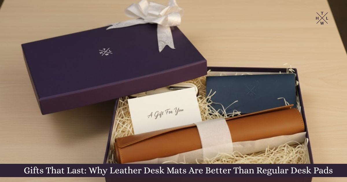 A premium gift box containing a rolled leather desk mat, a blue leather accessory, and a gift card displayed on shredded filler paper, promoting leather desk mat gifting for a stylish and durable workspace setup.