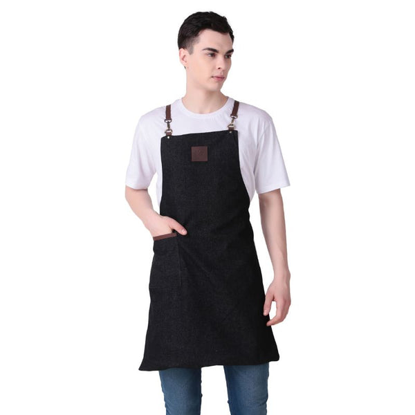 Person wearing a black apron with brown straps on a white background