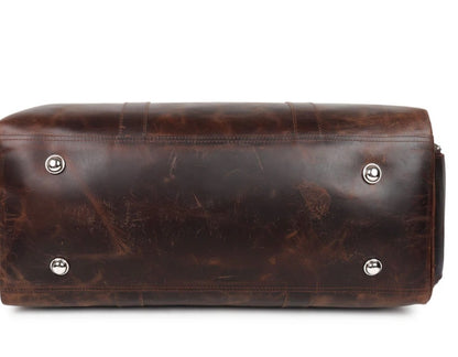 Brown leather bag with silver studs on a white background