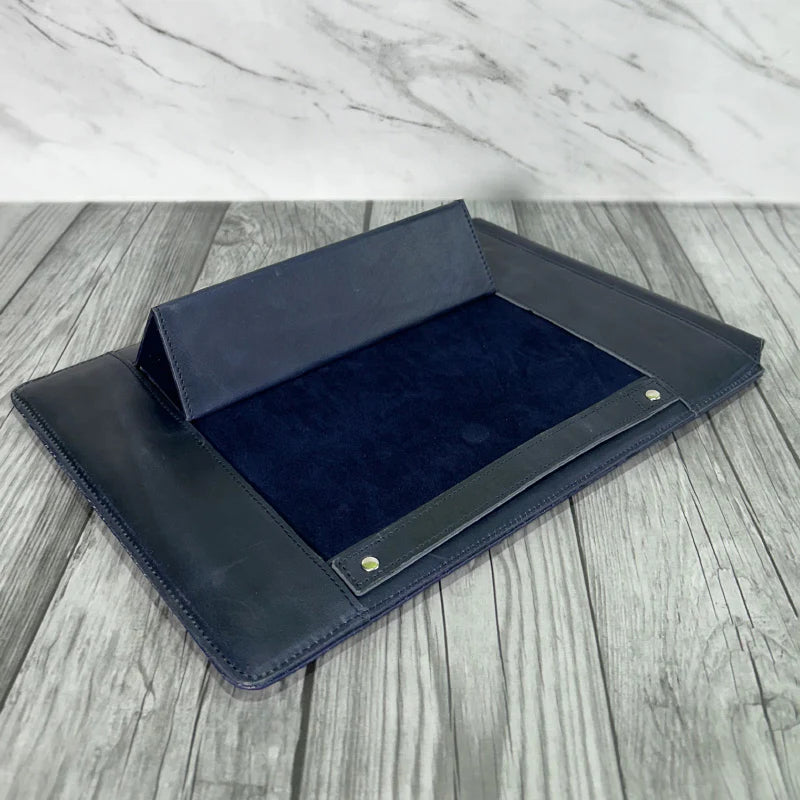 Blue leather laptop sleeve tray on a wooden surface
