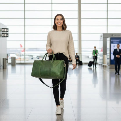 Woman holding a green travel bag in an airport terminal