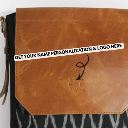 Brown leather sling bag with a brand logo on a white background
