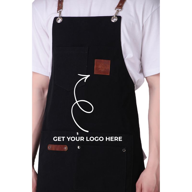 Black apron with customizable logo area worn by a person on a white background