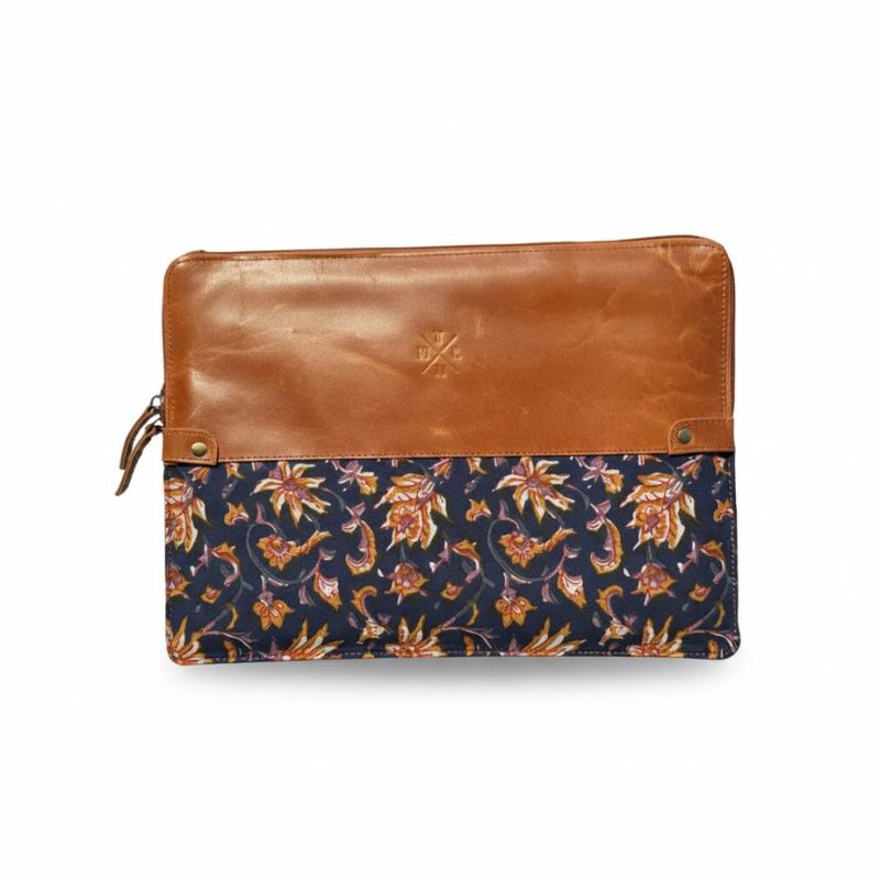 Floral-patterned pouch with brown leather top on a white background