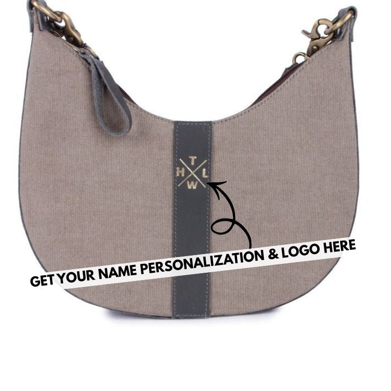 Brown sling handbag with a black stripe featuring a logo, on a white background.