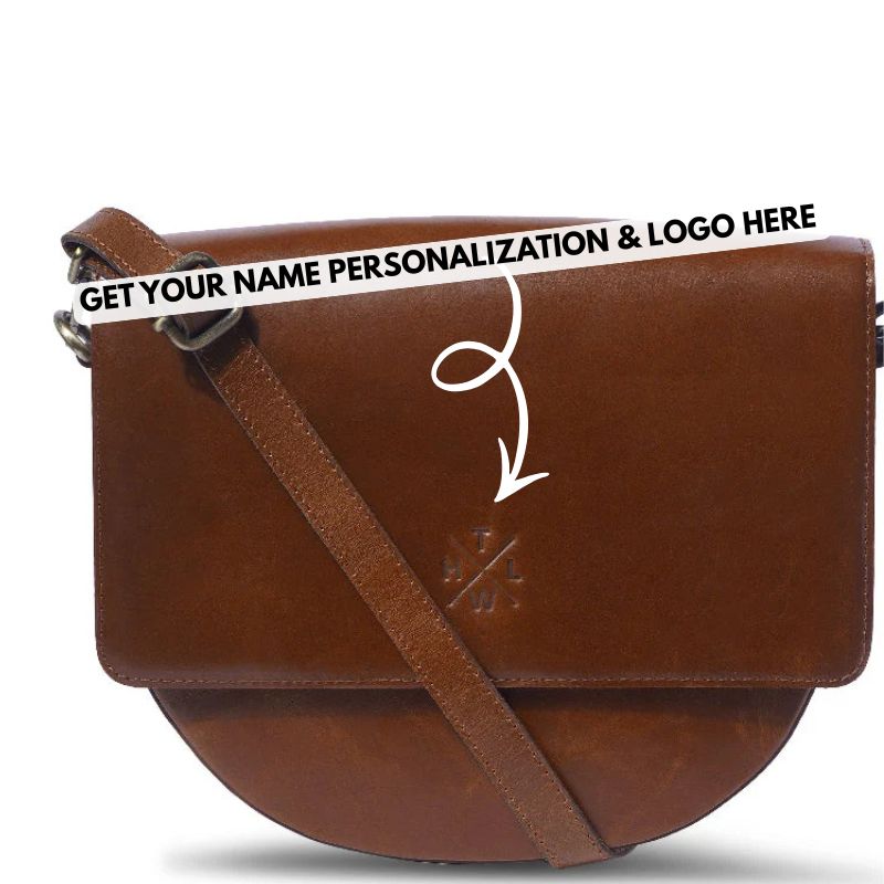 Brown leather sling crossbody bag with customizable text on a white background