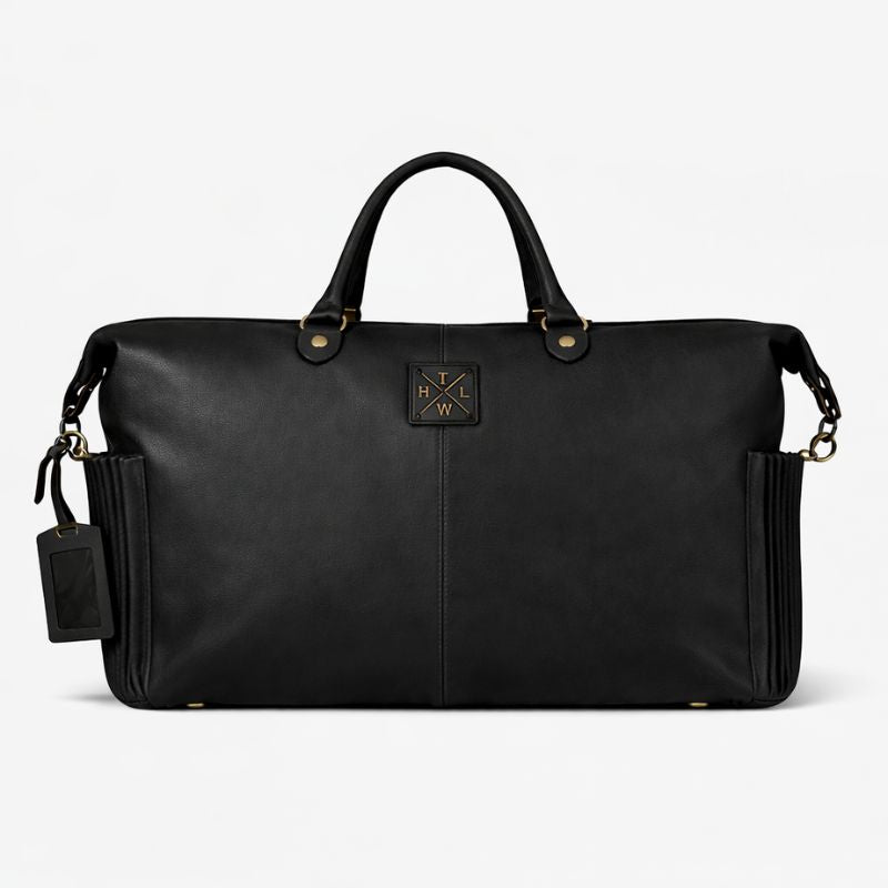 Black leather duffel bag with gold accents on a white background